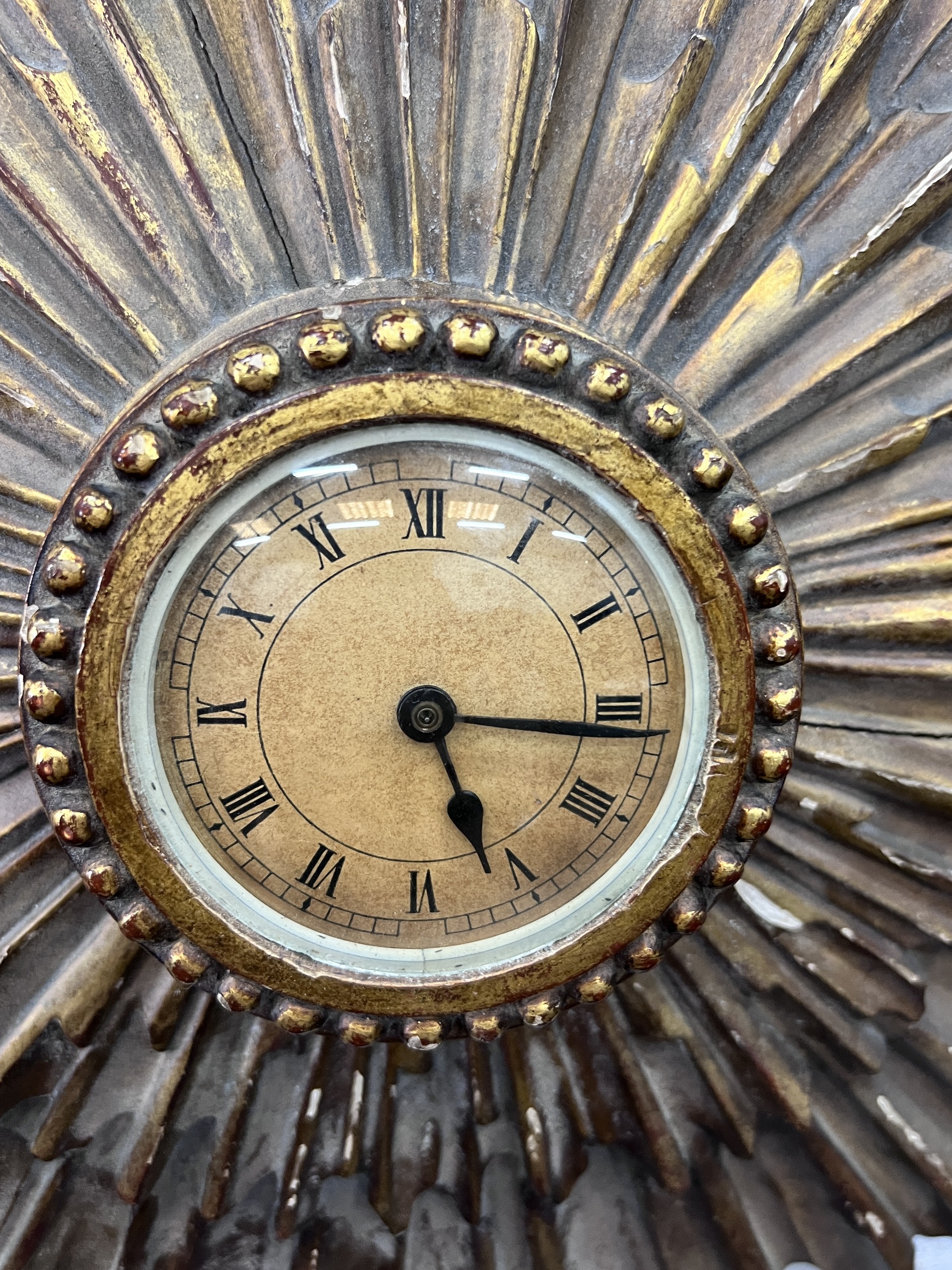 An early 20th century sunburst wall timepiece, diameter 50cm